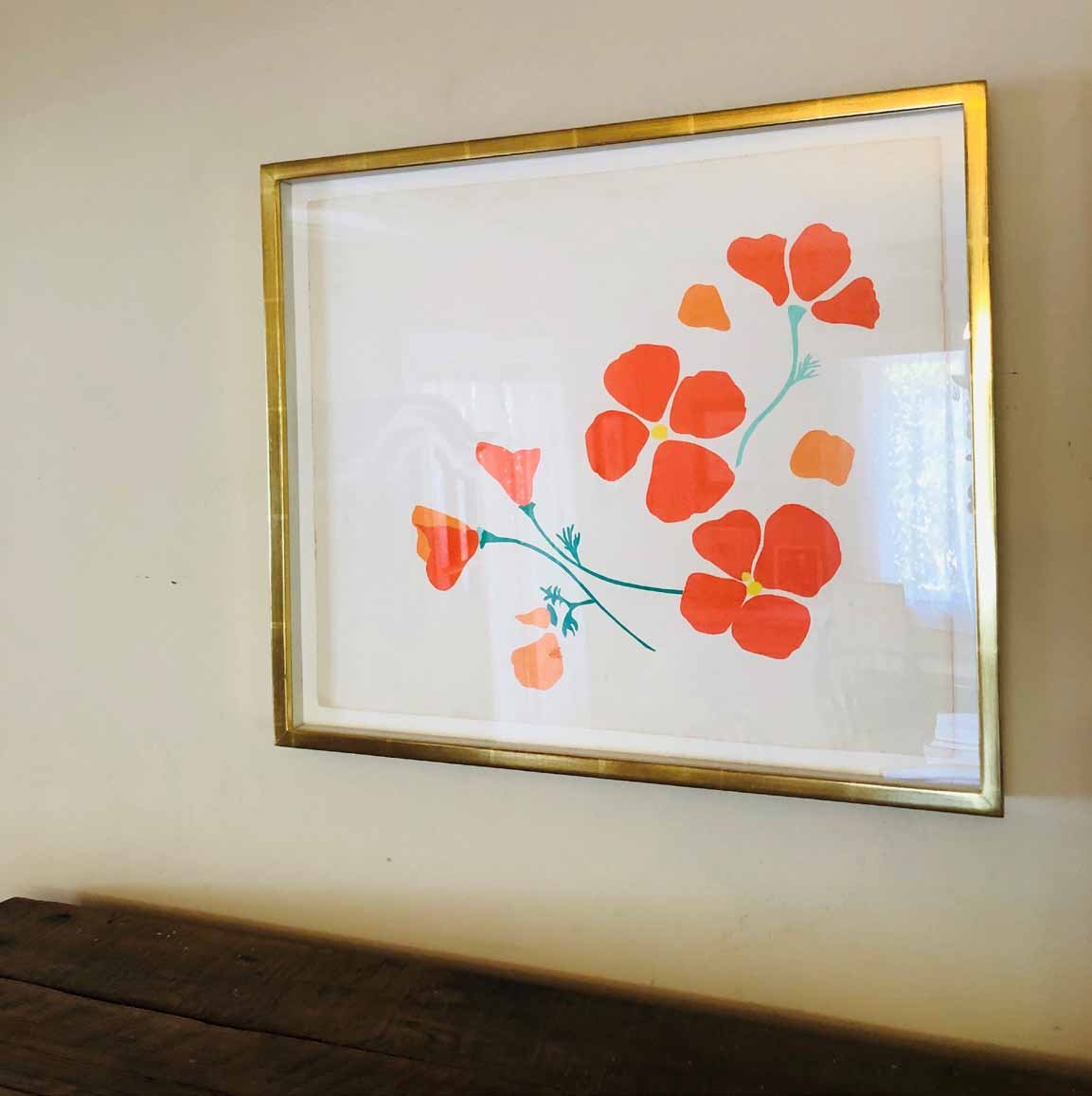 Framed paper cuts of California poppies